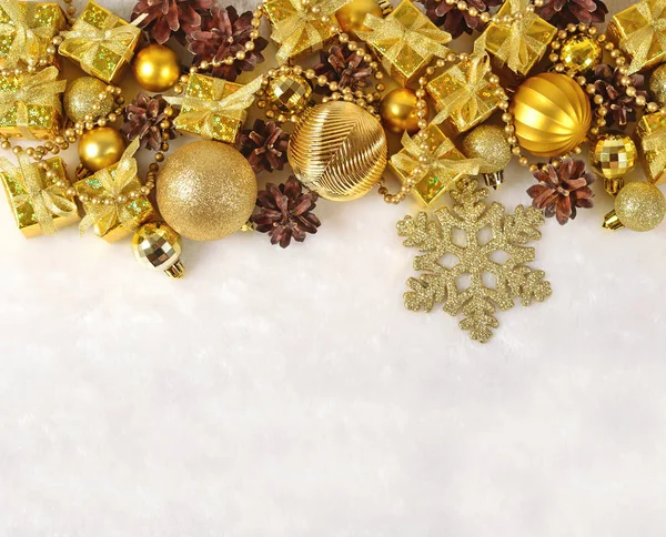 Golden Christmas decorations on a white — Stock Photo, Image