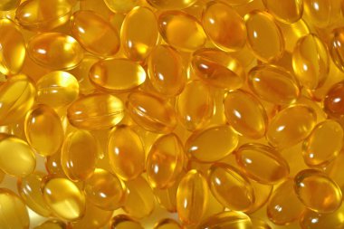 Omega-3 balık yağı kapsülleri arka plan olarak şişko.