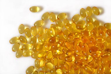 Omega-3 balık yağı kapsülleri beyaz bir arka plan üzerinde yakın çekim şişman.