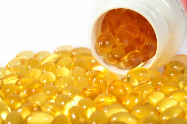 Omega-3 fish fat oil capsules in a bottle