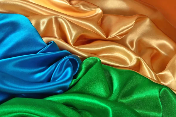 Natural golden, blue and green satin fabric texture