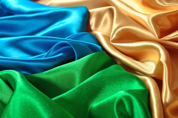 Natural golden, blue and green satin fabric texture