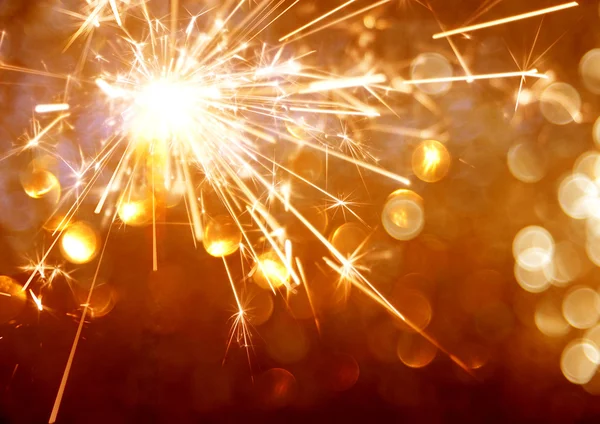 Sparkler on bokeh background — Stock Photo, Image