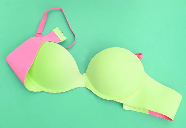 Green bra on green background — Stock Photo, Image