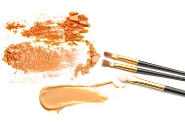 Beyaz arka plan üzerinde izole bej ve turuncu ezilmiş göz farı ve makyaj fırçası