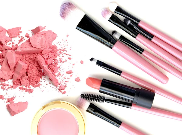 Crushed make up powder and lipstick samples with brushes on white background — Stock Photo, Image