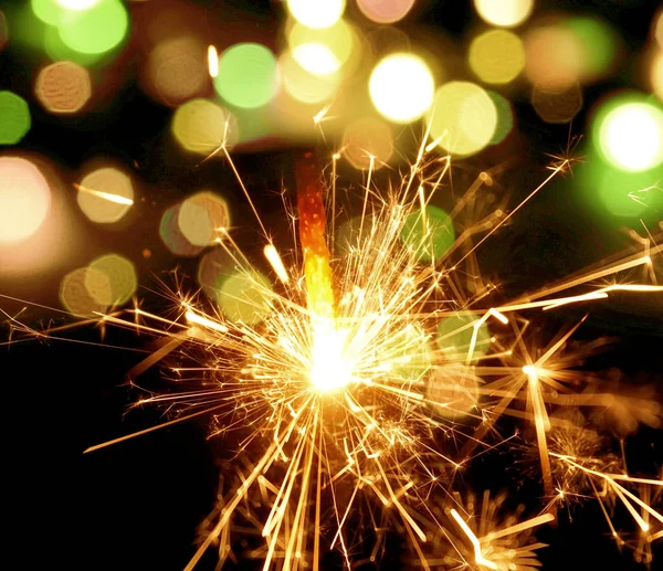 Holiday background with a sparkler — Stock Photo, Image