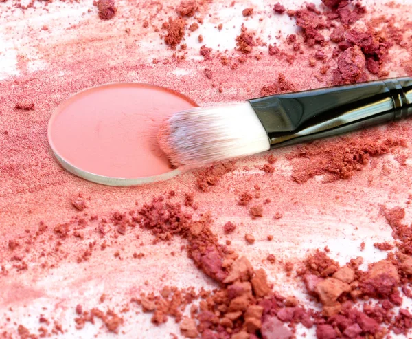 Crushed make up powder with brush cosmetic.