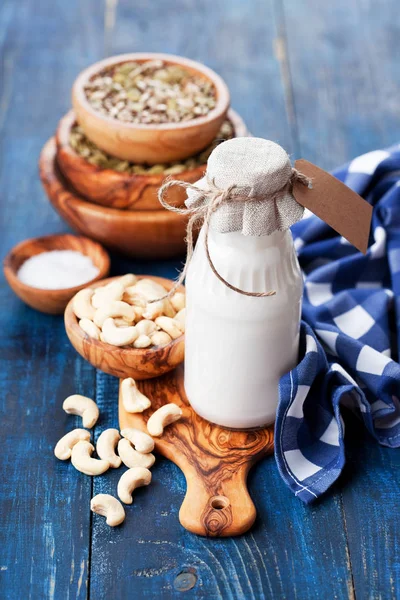 Raw vegan cashew milk in glass bottle — Stock Photo, Image