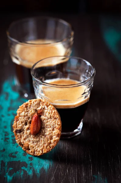 Two glasses of espresso and cookie with almonds — Stock Photo, Image