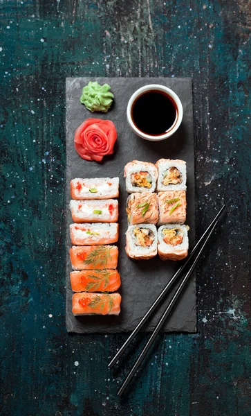 Sushi rolls served on stone slate — Stock Photo, Image