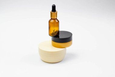 Set of cosmetic products with serum, face cream on a light background. Salon procedures concept. Minimalism.