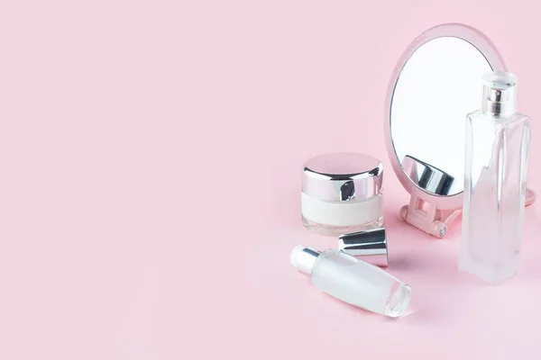 Face care cosmetics. Jars of cream and face serum on a pink background. Beauty Salon Concept — Stock Photo, Image