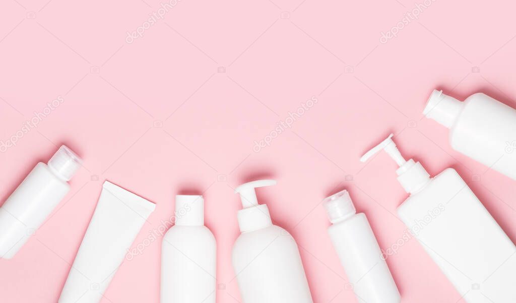 White cosmetic jars on a pink background. Cosmetics for skin care