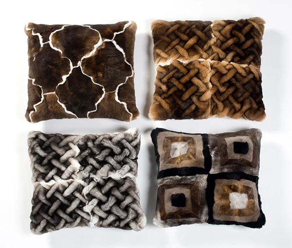 Four fur pillows with different designs — Stock Photo, Image