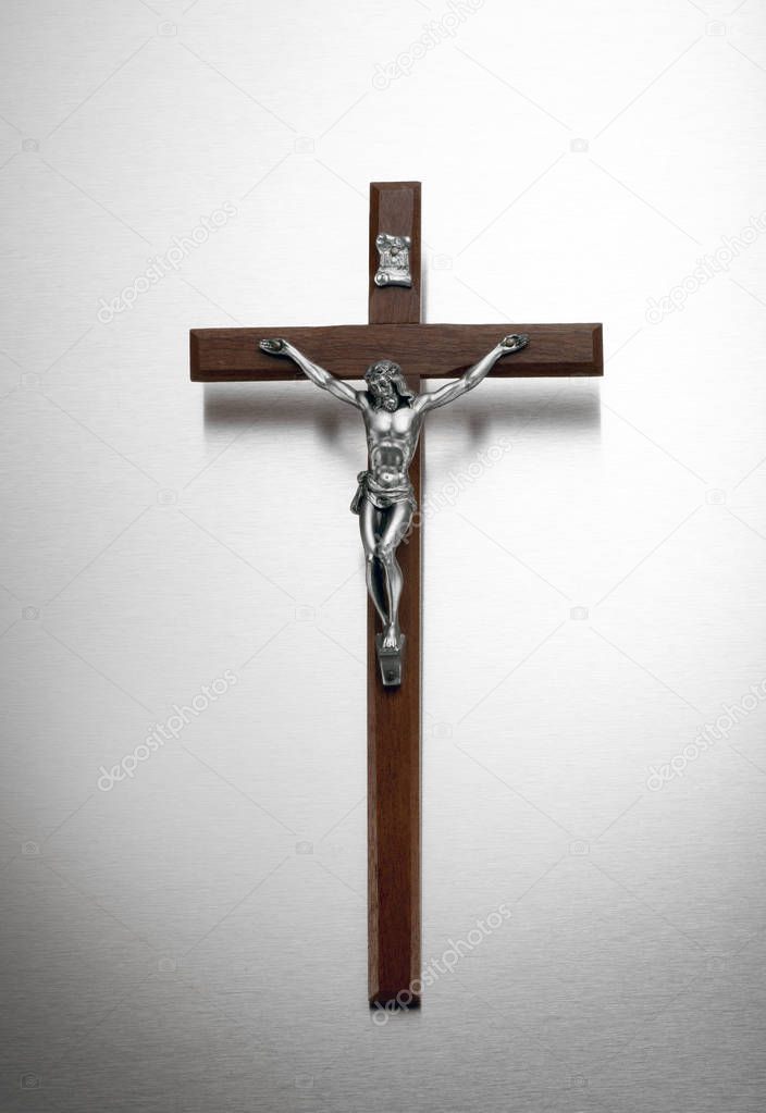 Silver and wood crucifix on a metal background