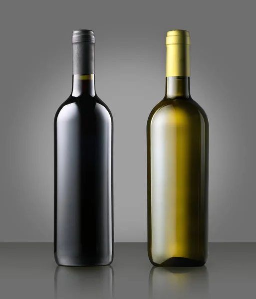 Unlabelled red and white wine bottles on gray