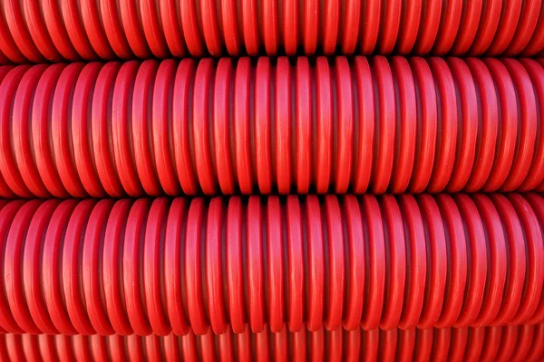 Red corrugated plastic pipes background Royalty Free Stock Photos