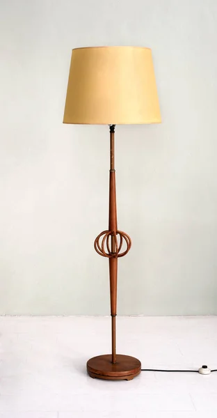Stylish wooden floor lamp with yellow shade