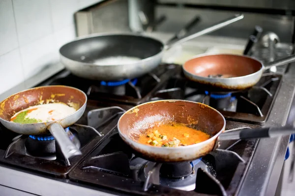 Savory sauces for pasta cooking on a gas burner — Stock Photo, Image