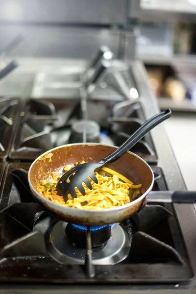 Italian tagliatelle pasta cooking on a burner — Stock Photo, Image