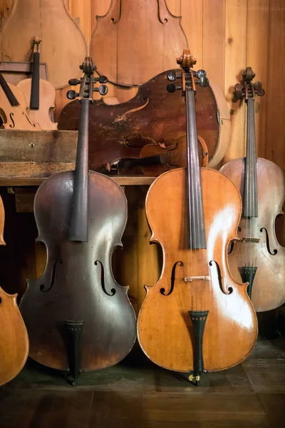 Cellos de pé em oficina luthier — Fotografia de Stock