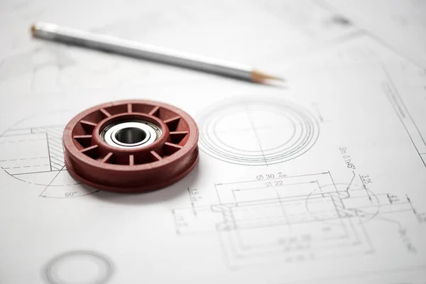 Plastic wheel bearing on blueprint — Stock Photo, Image