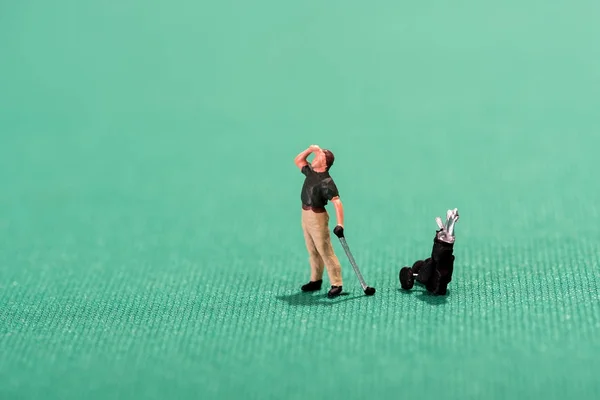 Miniature golfer peering into the distance