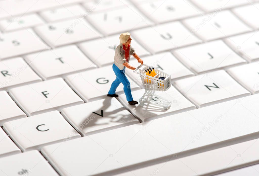 Shopper pushing a trolley over a computer keyboard