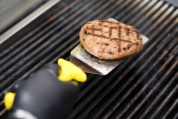 Chef cucinare un hamburger patty su una griglia — Foto Stock