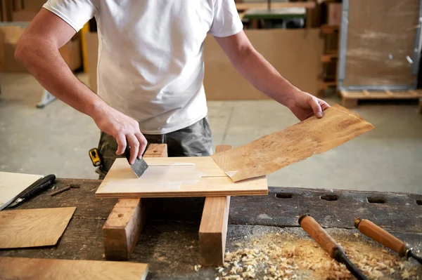 Carpenter applying glue to attach briar root panel — Stock Photo, Image