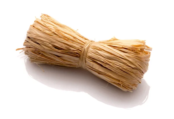 Roll of natural raffia on a white background — Stock Photo, Image
