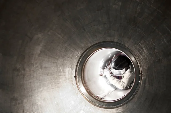 Welder or metal worker working inside a tunnel — Stock Photo, Image