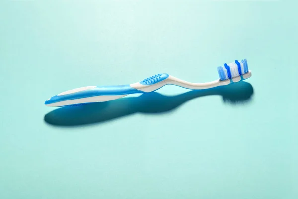 Blue White Toothbrush Shadow Green Background Copy Space Dental Hygiene — Stock Photo, Image