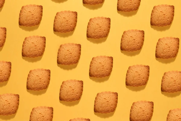 焼きや食べ物はまだ完全にフレームビューで黄色の斜線できれいに配置されたカリカリクッキーの生活の背景 — ストック写真