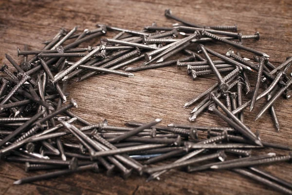 Iron nails on wooden background — Stock Photo, Image