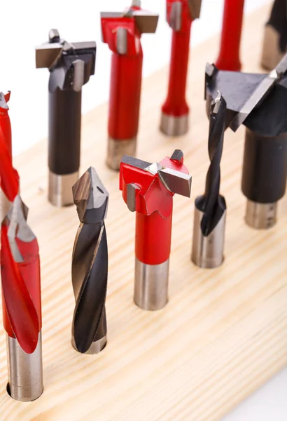 Various shapes drill bits for wood on wooden stand. close-up — Stock Photo, Image