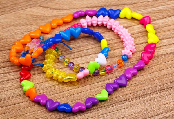 Bead bracelet with beautiful handcrafted wooden background — Stock Photo, Image