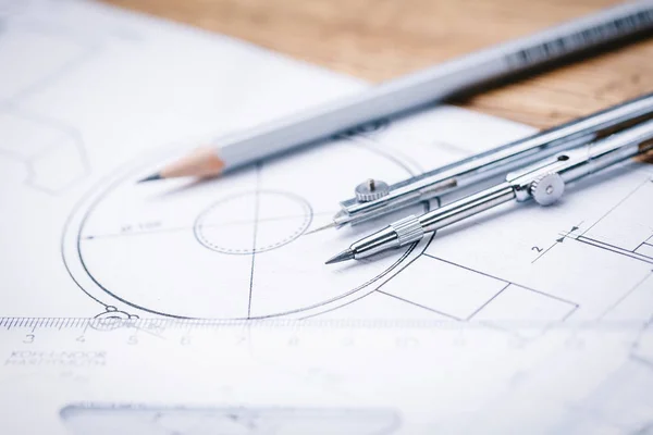 Bouwkundige tekeningen. Architecturale broodjes en een tekening instrumenten op de werktafel. Tekening kompas, plannen. — Stockfoto