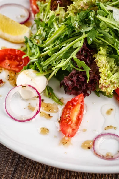 Mixed salad with tomatoes and mozzarella. — Stock Photo, Image