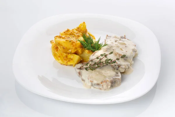 Delicious lunch. Potatoes in French mustard with meat in mushroom sauce — Stock Photo, Image