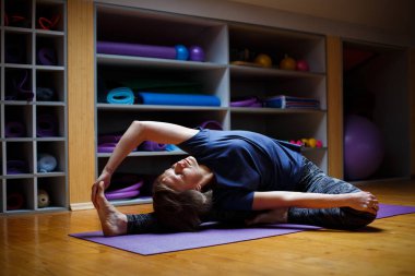 Genç çekici gülümseyen kadın spor salonunda Yoga uygulamak