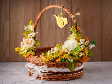 Festival sepeti ahşap zemin üzerine çiçeklerle süslenmiş.