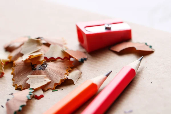 Red sharpener with pencils on the table — Stock Photo, Image