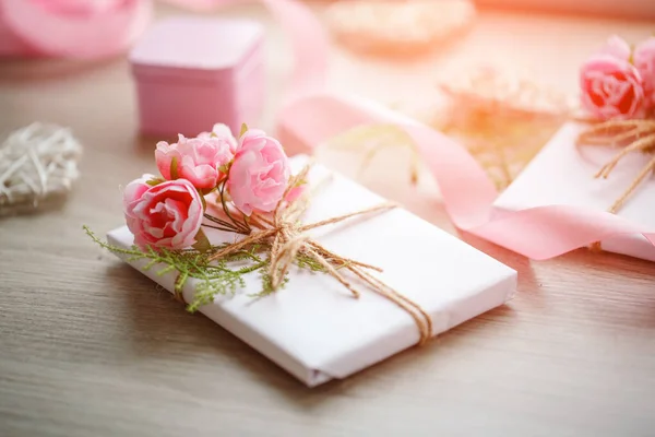 Composición con cajas de regalo decoradas con rama verde y rosa . — Foto de Stock