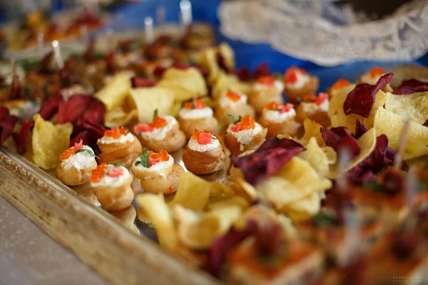 Lekkere snack aan de buffettafel op een houten dienblad. — Stockfoto