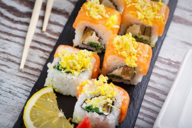 Taş tahtada somon ve limonlu suşi seti. Lezzetli restoran yemeği