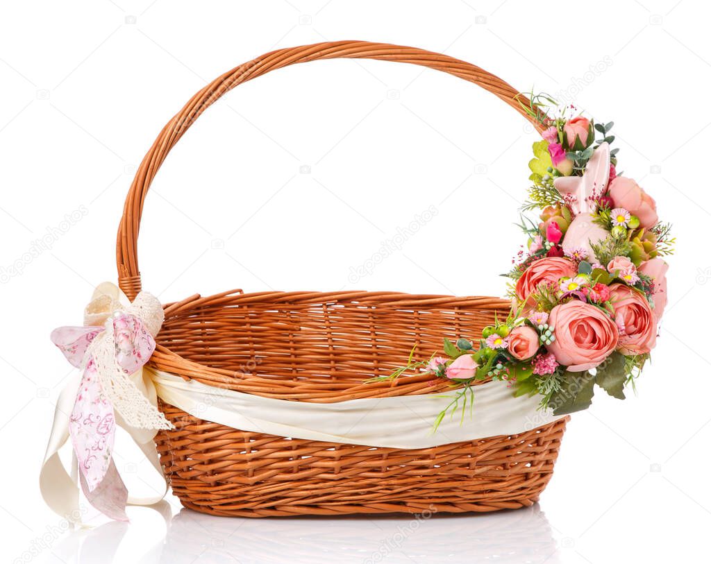 Beautiful easter floral decor in pink on a brown wicker basket on a white background.