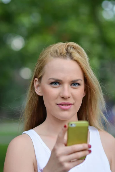 Young blonde girl with smart phone — Stock Photo, Image