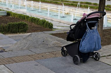 Photo of a stroller near the water fountains in front of the National Palace of Culture, suitable for cool Bulgarian beauty, Sofia, Bulgaria   clipart